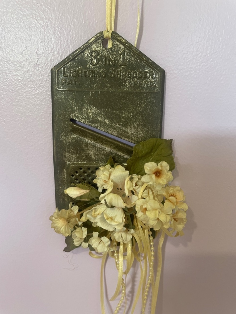 Vintage metal shredder repurposed with flowers - wall hanging